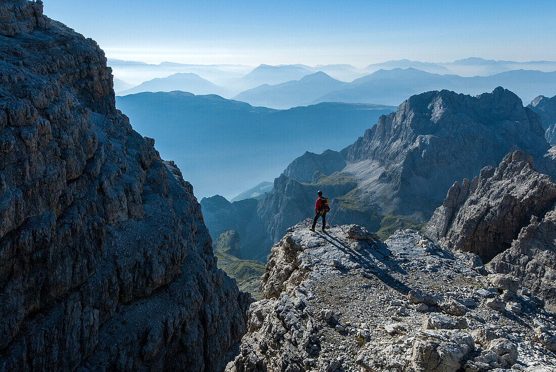 Brenta Dolomites, Trentino, Italy. Mountaineer admiring the view from the via ferrata Bocchette Alte