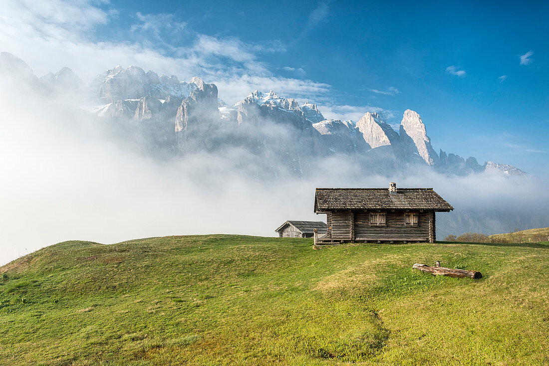 Passo Gardena, Dolomites, South Tyrol, Italy. Mountain hut in front of the mountains of the Sella group