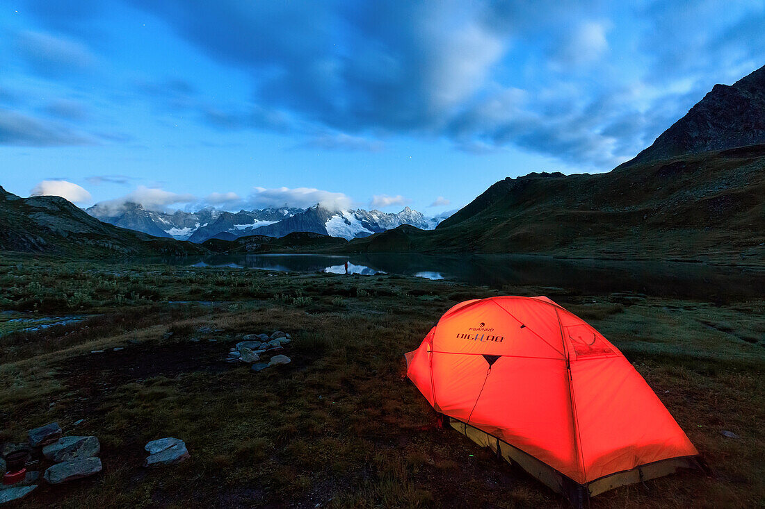Lights of a tent around Fenetre Lakes at dusk, Ferret Valley, Saint Rhemy, Grand St Bernard, Aosta Valley, Italy, Europe