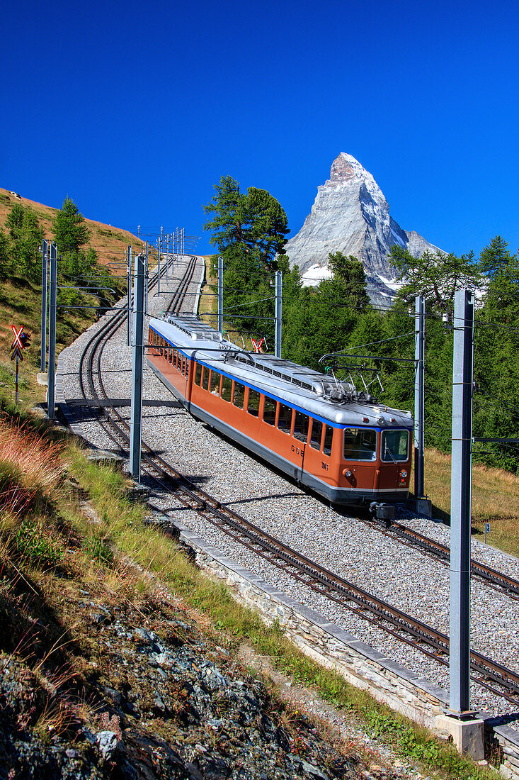 The swiss Bahn train runs on its route with the Matterhorn in the background, Gornergrat, Canton of Valais, Swiss Alps, Switzerland, Europe