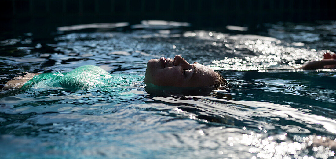 A woman floats in a swimming pool at the Koh Jum Resort on the island of Koh Jum, Thailand, on May 3, 2015.