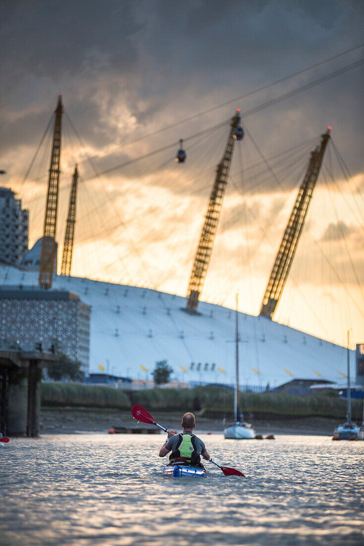 Kayaking on the River Thames at sunset by the O2 Arena, Greenwich, London, England, United Kingdom, Europe