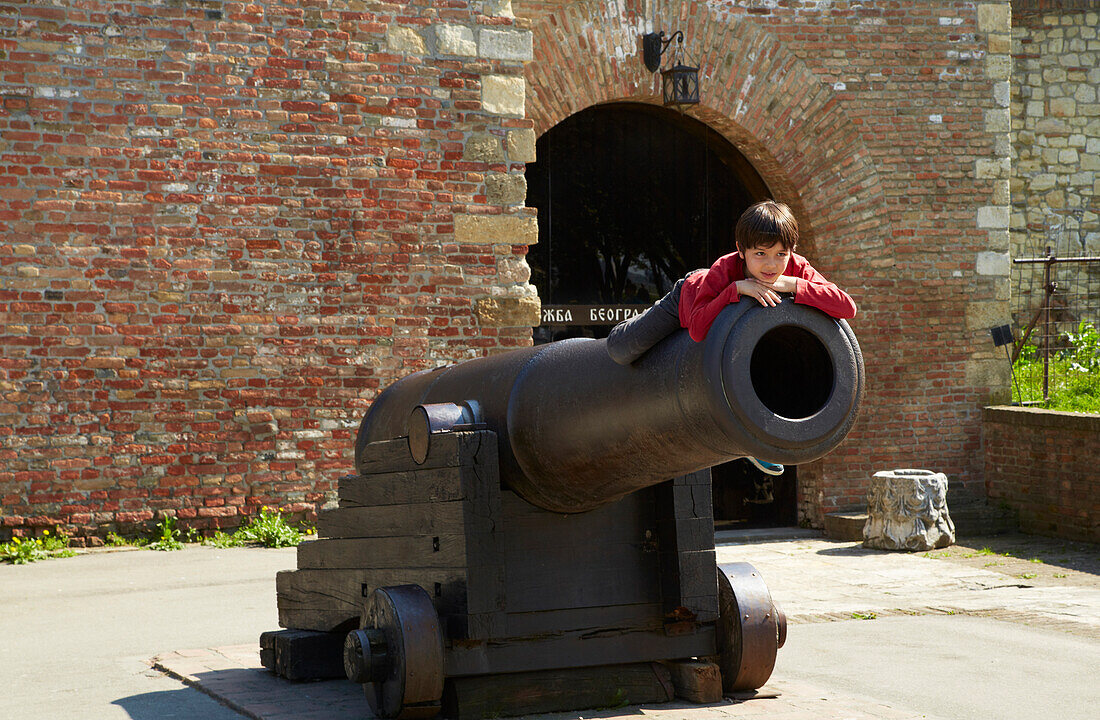 Belgrad , Kalemegdan Fortress , Boy lies on Cannon , River Save , River Danube , Serbia , Europe