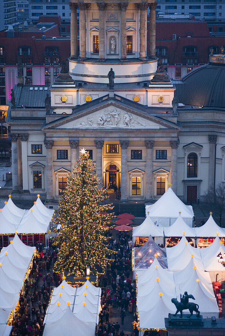 Germany, Berlin, Mitte, Gendarmenmarkt, Christmas market, elevated view with Deutscher Dom, dusk.