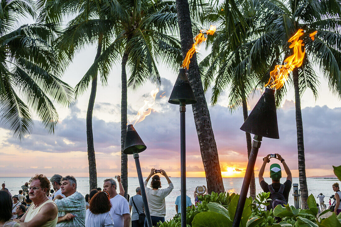 Hawaii, Hawaiian, Honolulu, Waikiki Beach, Kuhio Beach Park, Pacific Ocean, sunset, Waikiki Bay, palm trees, tiki lanterns, lit, fire,.