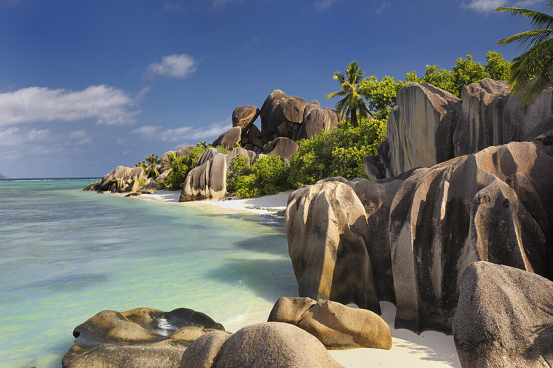 Famous beach Anse Source d´Argent with palm trees and sculpted rocks, La Digue Island, Seychelles, Indian Ocean.