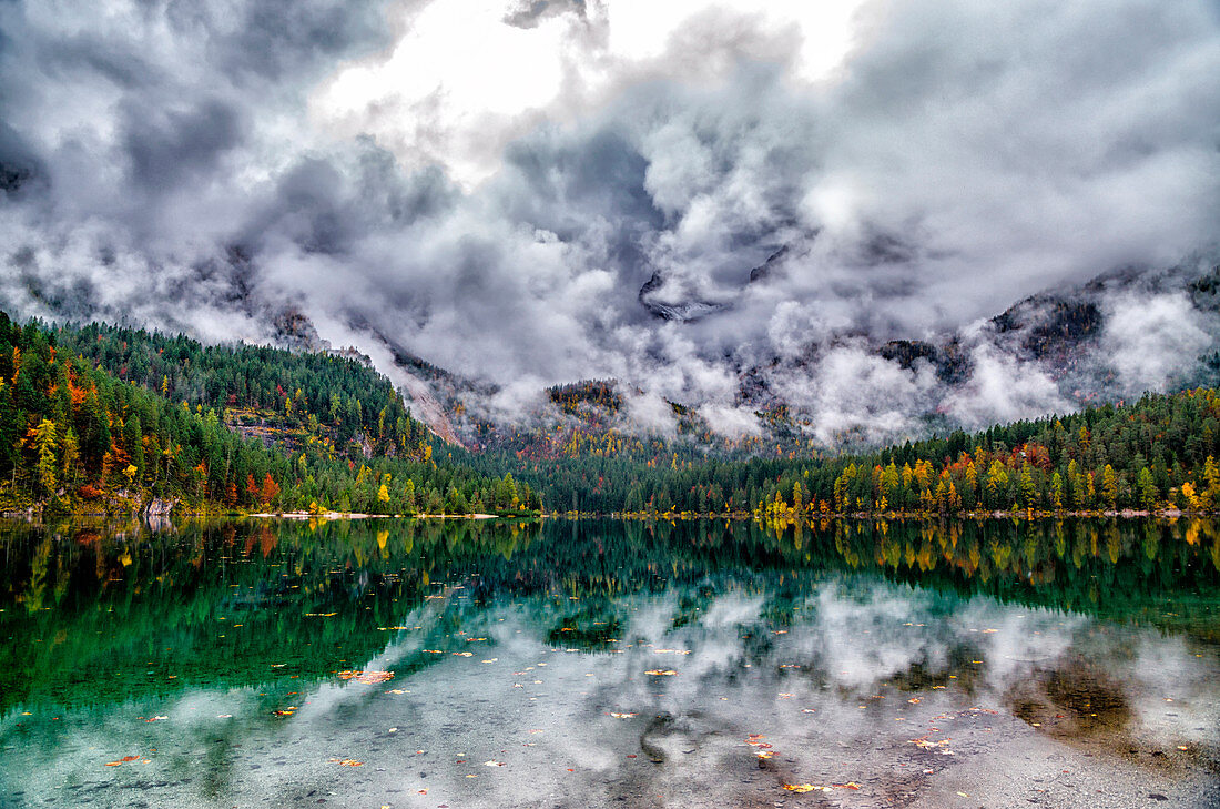 Italy, Trentino Alto Adige, Non valley, clouds reflected into Tovel lake in autumn.