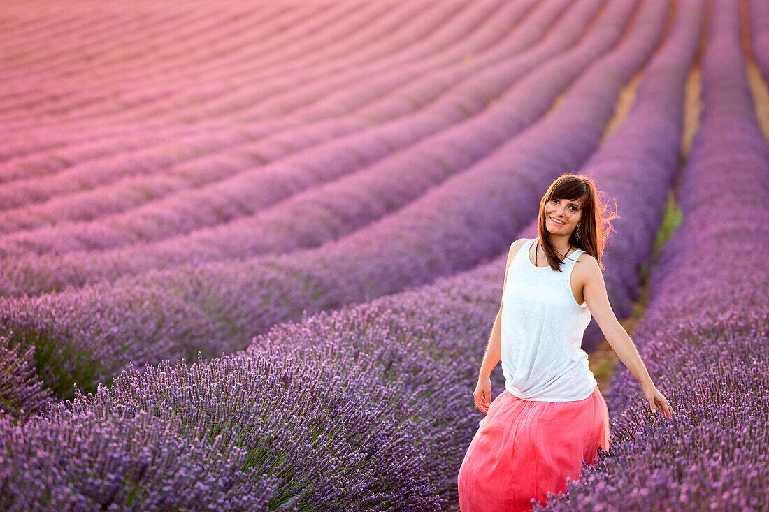 Valensole Plateau, Provence, France. Young girl at sunset in a lavender field in bloom