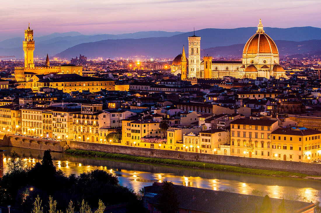 Florence, Tuscany, Italy. cityscape and Cathedral and Brunelleschi Dome, Giotto Tower. Sunset, lights on.