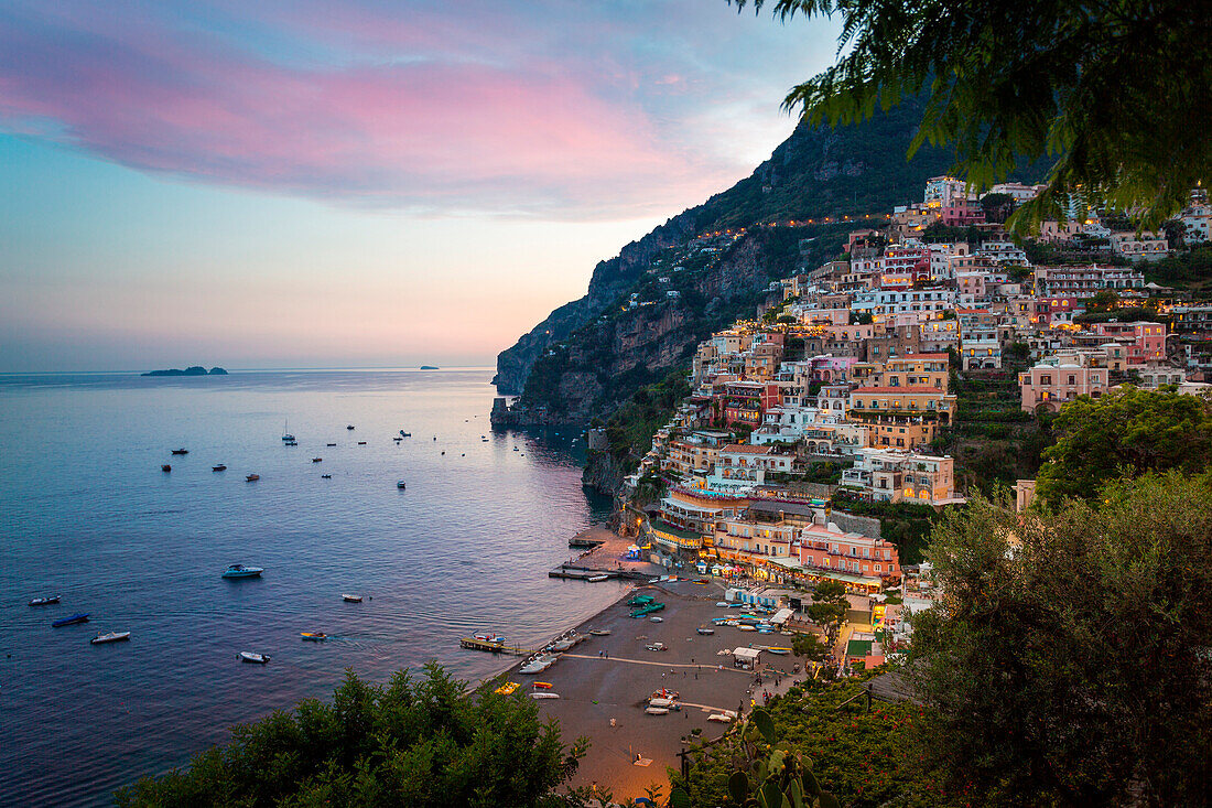 Positano, Amalfi Coast, Campania, Sorrento, Italy. View of the town and the seaside in a summer sunset