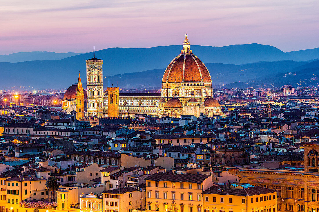 Florence, Tuscany, Italy. cityscape and Cathedral and Brunelleschi Dome, Giotto Tower. Sunset, lights on.