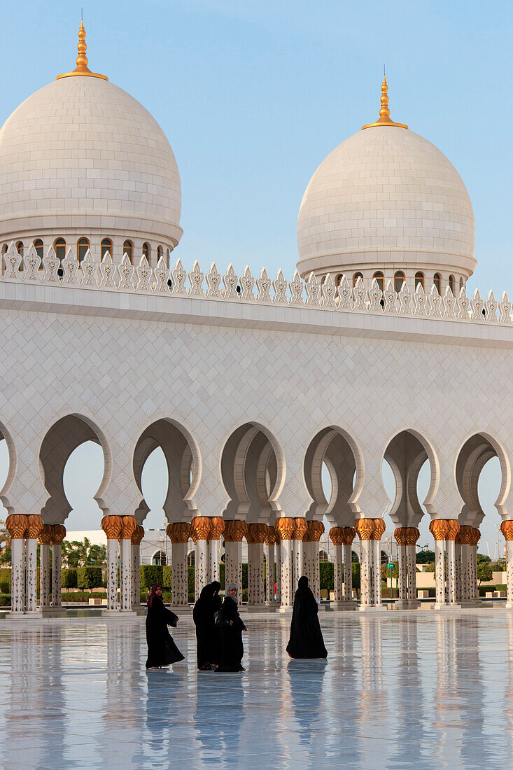Abu Dhabi, United Arab Emirate. Women walking on the Sheikh Zayed Grand Mosque