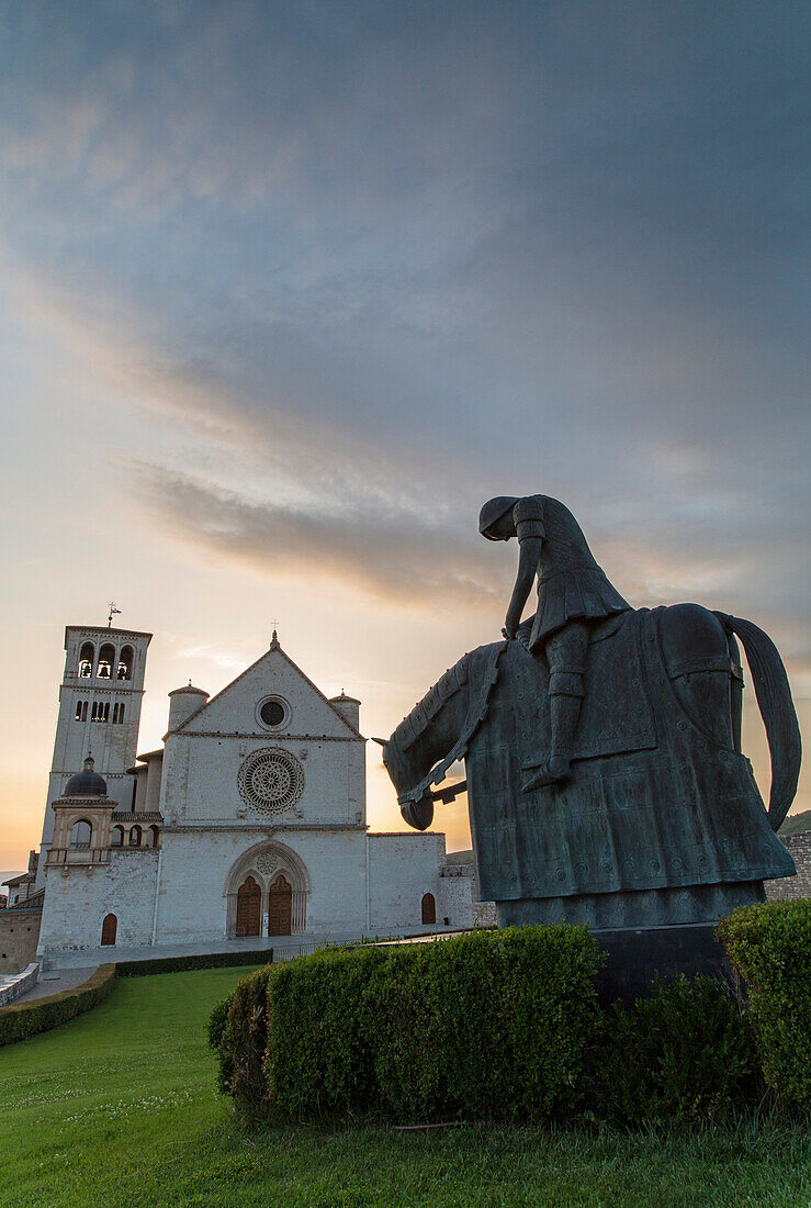 The statue, which depicts the return of Saint Francis to his father's house, in front of the basilica of St. Francis in Assisi, Umbria, Italy, europe