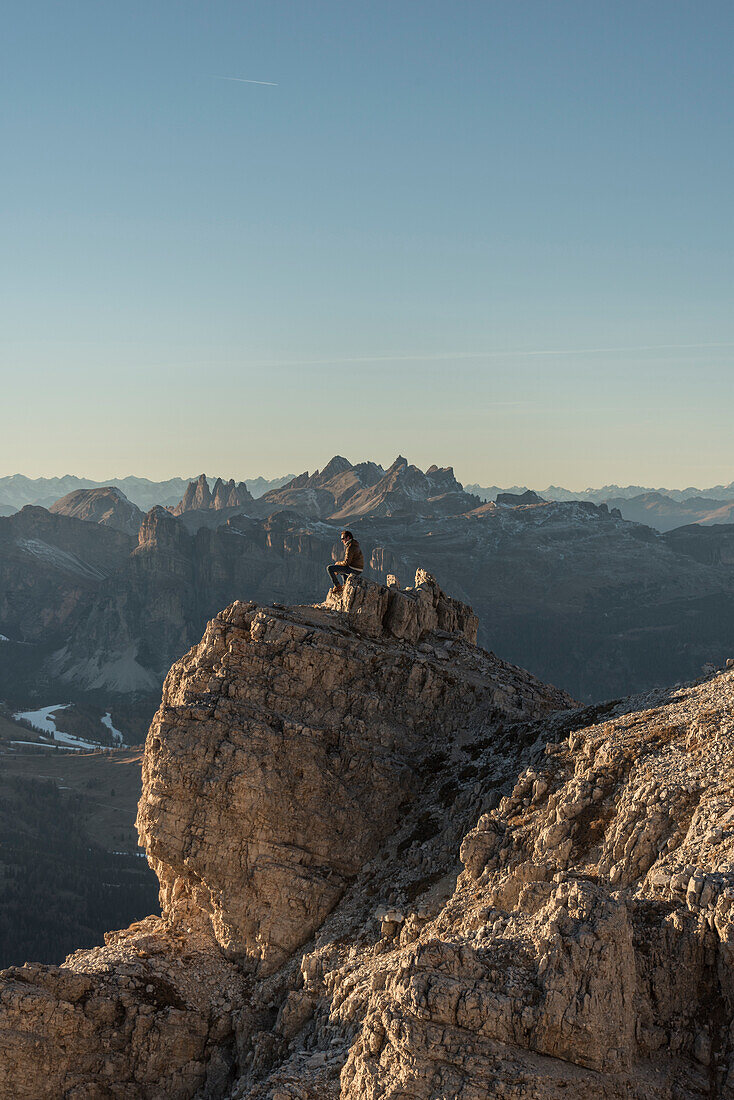 Puez, Odle, Lagazuoi mount, Falzarego Pass, Cortina d'Ampezzo, Dolomiti, Dolomites, Belluno, Veneto, Italy. Hiker looking at panorama from Lagazuoi.