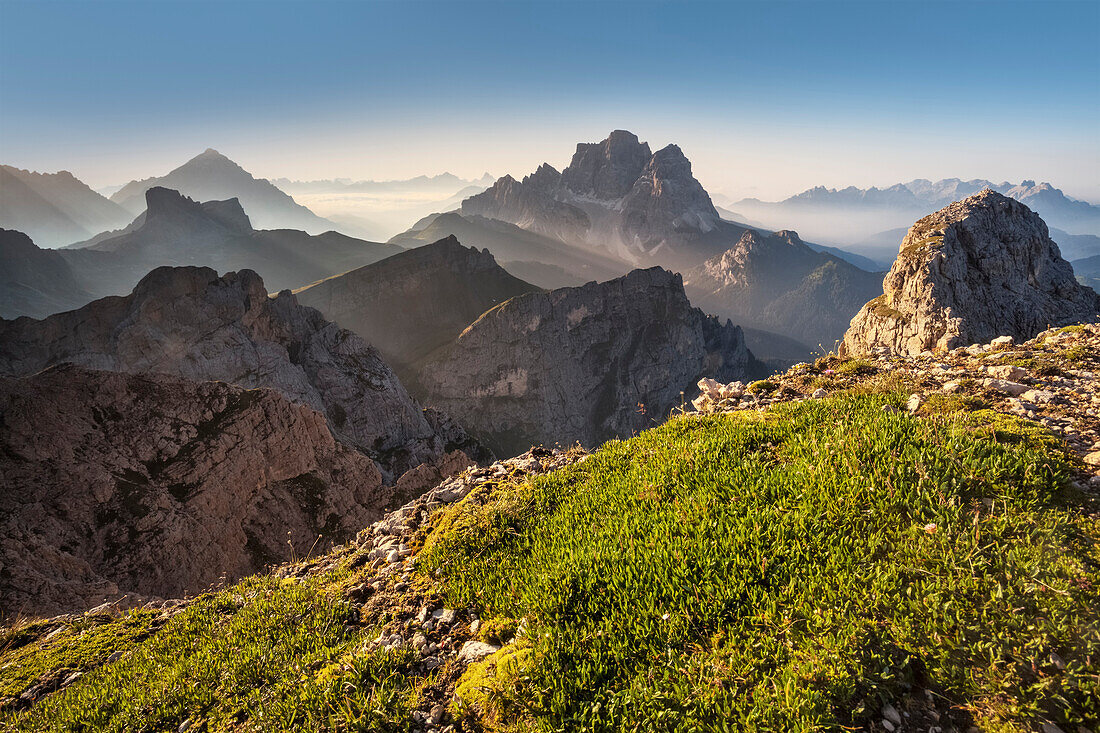 Europe, Italy, Veneto, Belluno. Rays of light behind the Pelmo and the Antelao, as seen from Mount Cernera, Dolomites