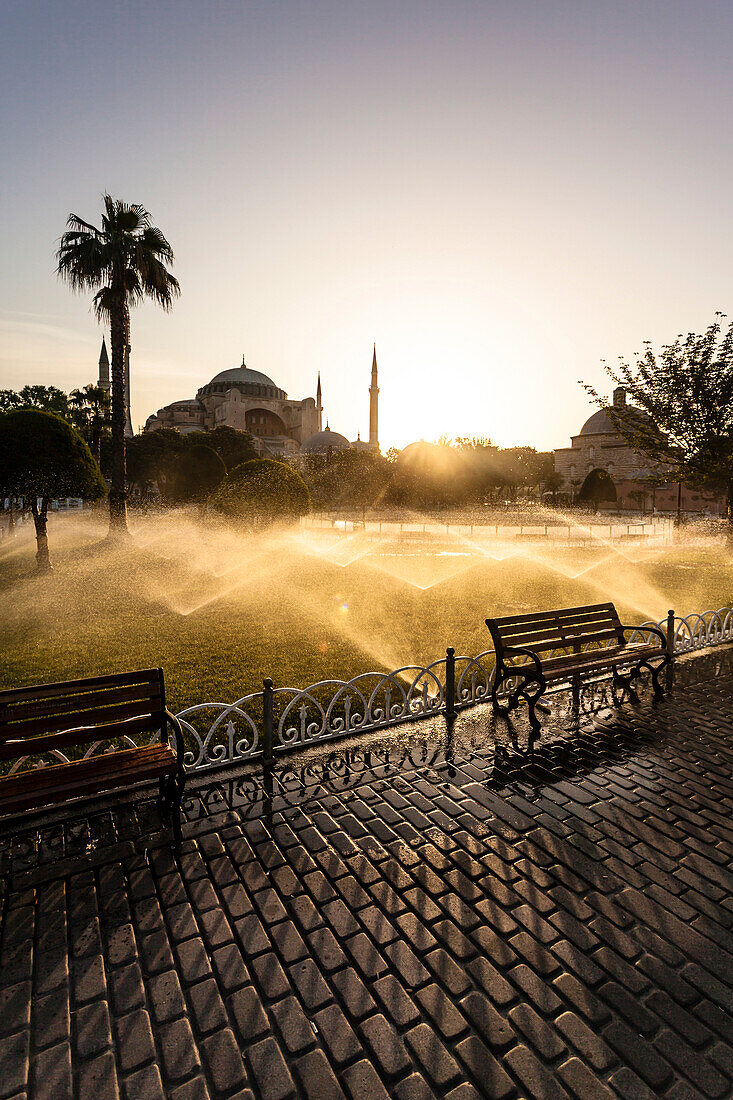 In the Sultan Ahmet Park park at the Hagia Sophia the lawn is watered during the sunrise, Istanbul, Turkey