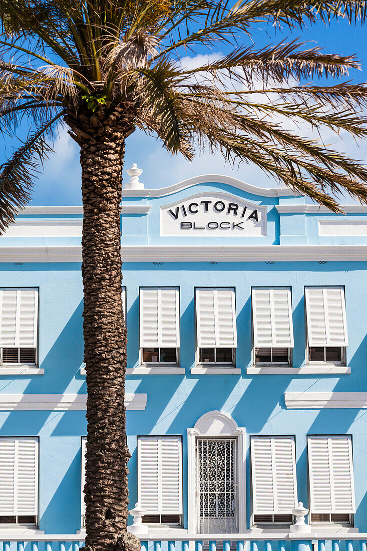 Blue house facade Victoria Block with a palm tree in the Front Street, historical Old Town, Hamilton, Island Bermudas, Great Britain