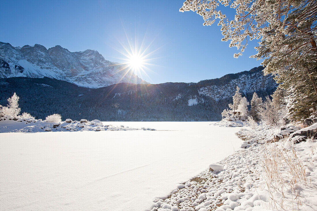 View over the frozen Eibsee to the Zugspitze, near Grainau, Bavaria, Germany