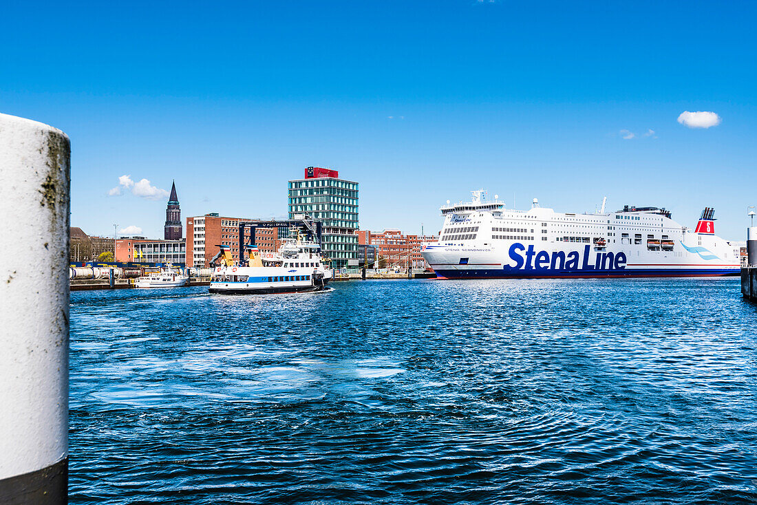 The ferry to Sweden and the passenger ferry on the Kieler Förde in the harbour with the city hall tower, Kiel, Schleswig Holstein, Germany