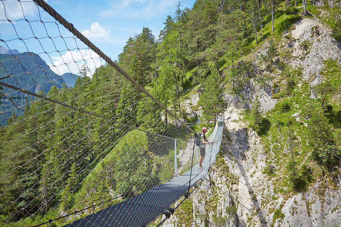 Woman at a rope bridge