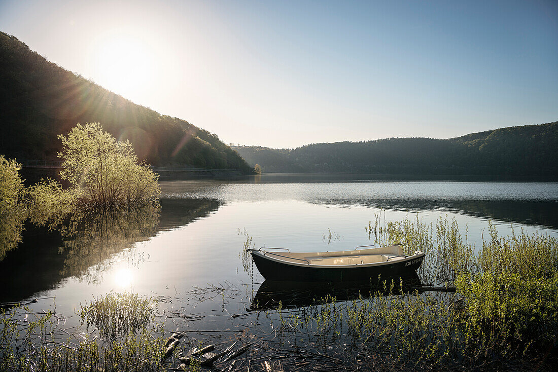 boat Lake Eder while sun rises, National Park Kellerwald-Edersee, Hesse, Germany