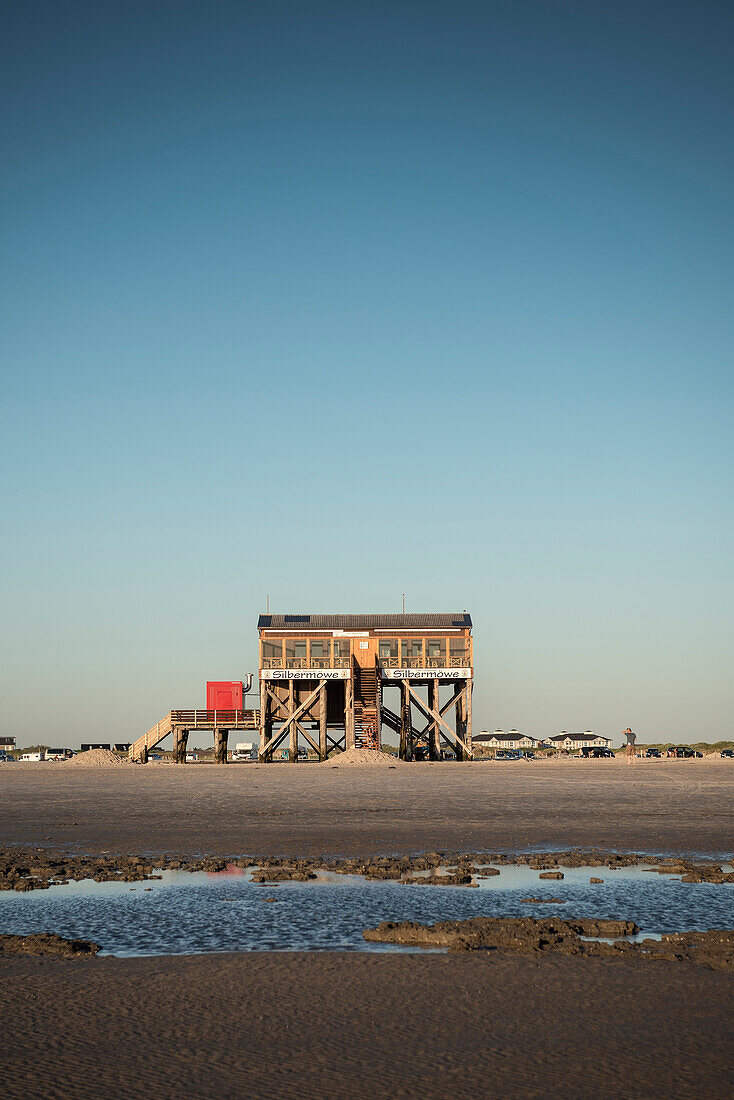 restaurant on stilts during low tide at beach of St. Peter Ording, UNESCO Wadden Sea, Germany