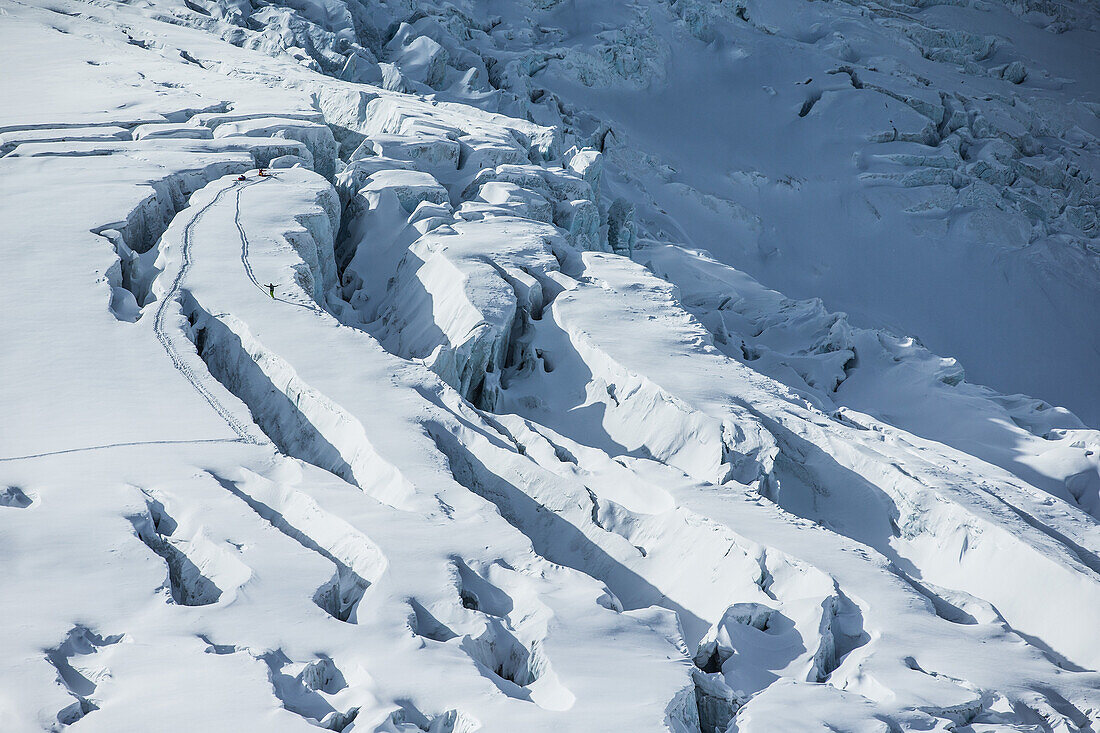 Three young winter sportspersons making a ski tour through the deep powder snow, Pitztal, Tyrol, Austria