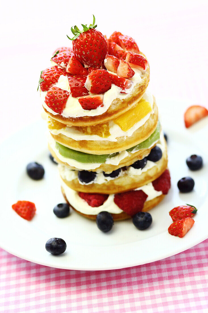 Stack of pancakes with berries and White cream on a white plate, Hong Kong, China, Asia