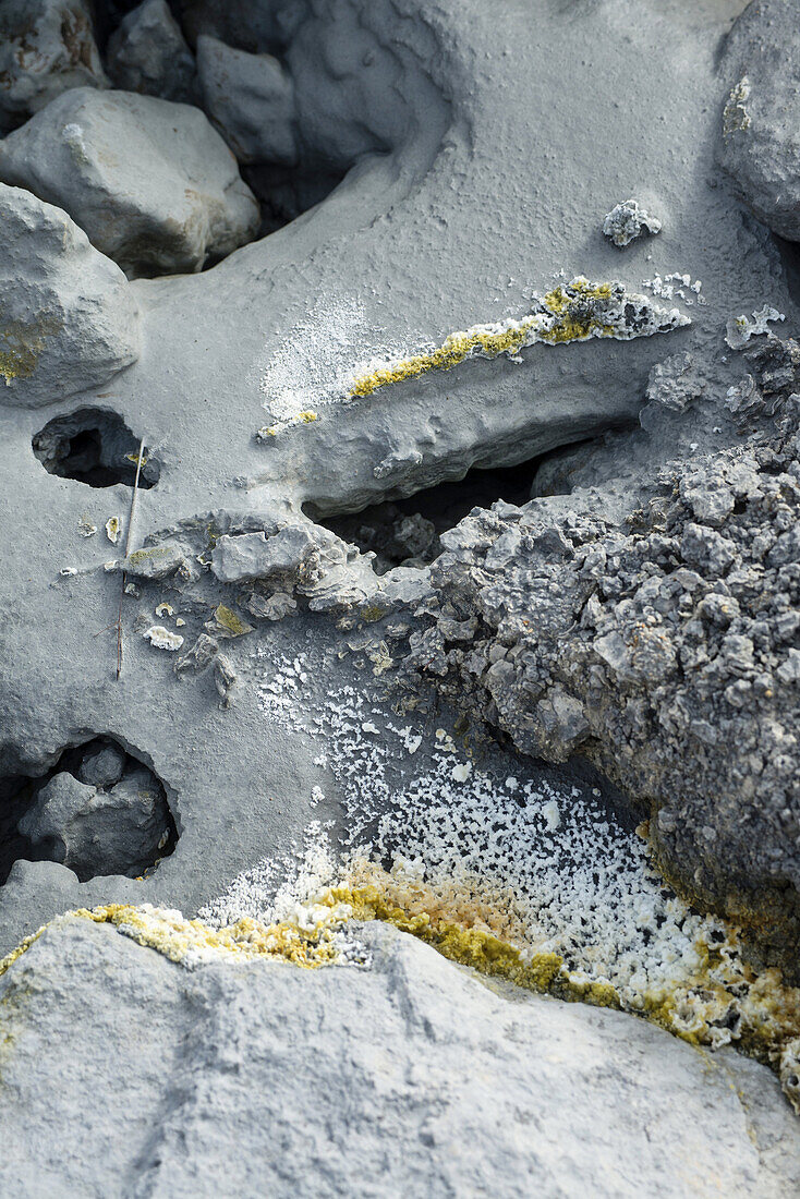 Hot water coming from undergound volcanic layers charged with Sulphur laying the mineral at the surface and forming sulphuric acid and foetid gases, thus forming a peculiar, colourful landscape.