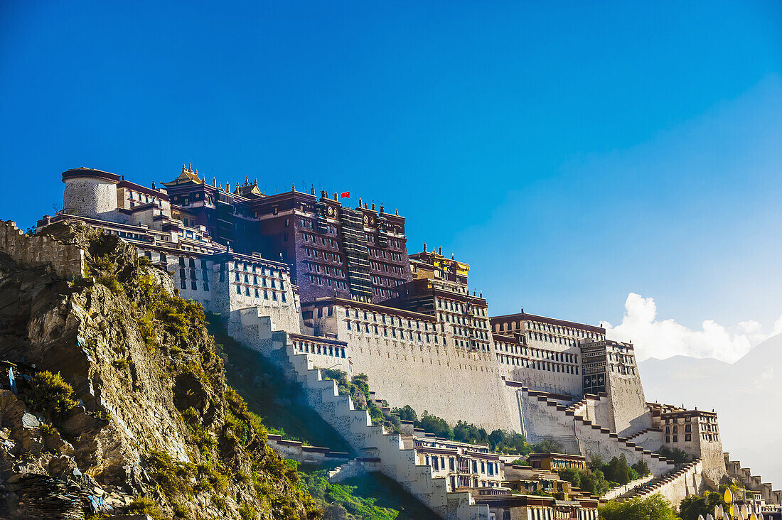 The Potala Palace (a UNESCO World Heritage Site) was the chief residence of the Dalai Lama until the 14th Dalai Lama fled to Dharamsala, India, during the 1959 Tibetan uprising. The massive palace contains 999 rooms. Lhasa, Tibet, China.