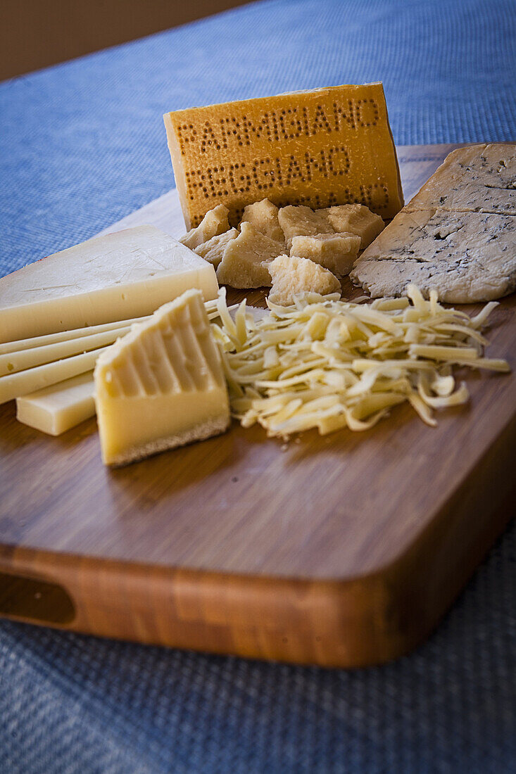cutting board with various cheeses - parmesan.