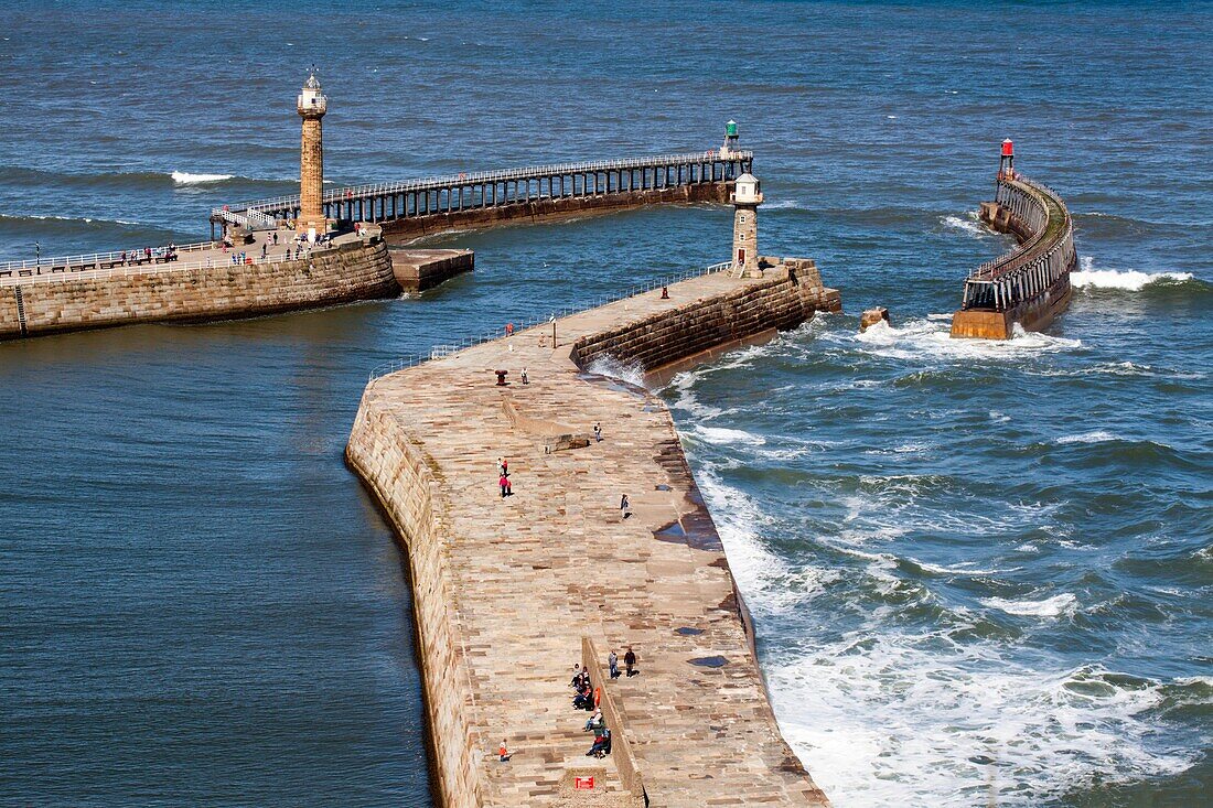 People Walking on the Piers at Whitby Yorkshire Coast England.