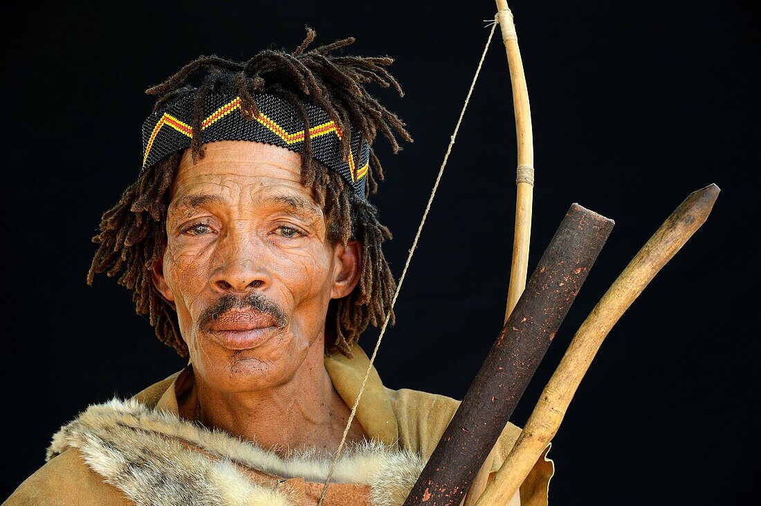 Portrait of Naro San Bushman, wearing traditional clothing and headband, Kalahari, Ghanzi region Botswana, Africa.