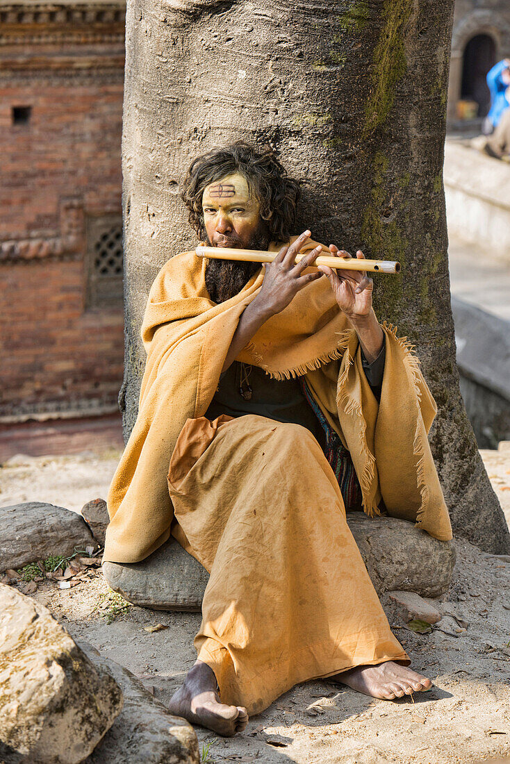 Sadhu playing his flute, Kathmandu, Nepal.