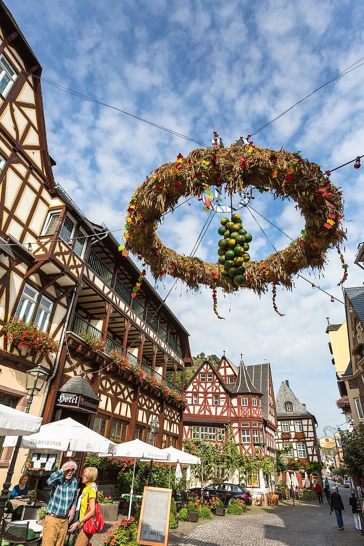 Picturesque timbered houses, 14th century Altes Haus (Old House) and harvest crown in Bacharach, Rhineland-Palatinate, Germany, Europe