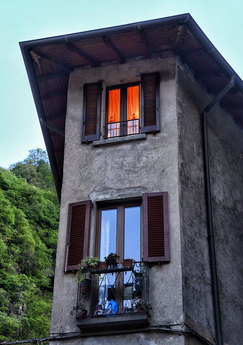 light in house window, historic part of Porlezza, Province of Como, Lombardy, Italy.