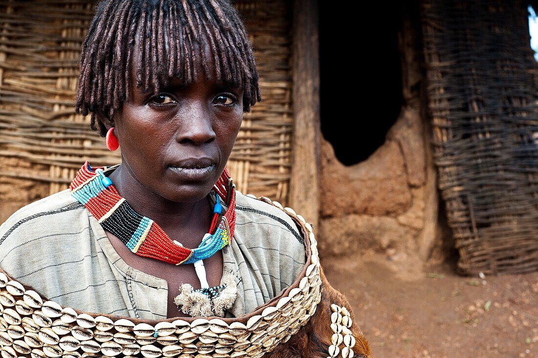 Woman belonging to the Banna tribe in front of her hut. Omo valley ( Ethiopia).