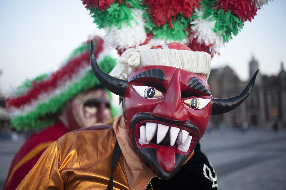 A dancer from Chocaman, Veracruz, dressed as a red devil, dances the Danza de los Santiagos at the pilgrimage to Our Lady of Guadalupe Basilica in Mexico City, Mexico, December 8, 2013.