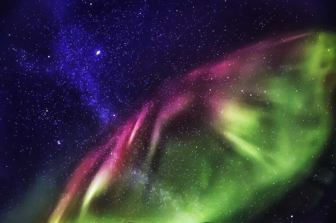 Starry evening with the Aurora Borealis or Northern Lights and the Milky Way Galaxy, Abisko, Lapland, Sweden.