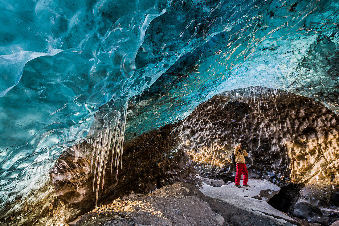 Exploring an Ice Cave on Svinafellsjokull Glacier in Skaftafell National Park, Iceland.