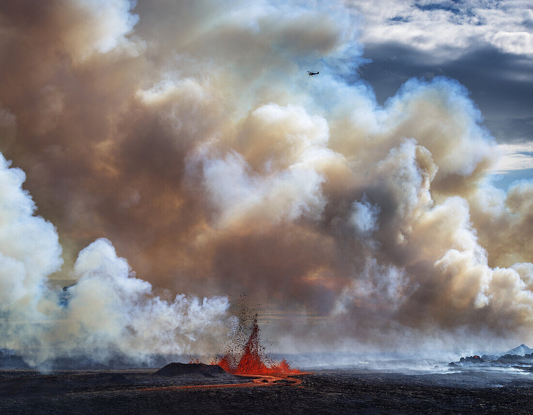 Volcano Eruption, Holuhraun-near the Bardarbunga Volacano, Iceland. Thick Plumes and Lava Fountains with a small plane flying over the eruption site. August 29, 2014 a fissure eruption started in Holuhraun at the northern end of a magma intrusion, from th