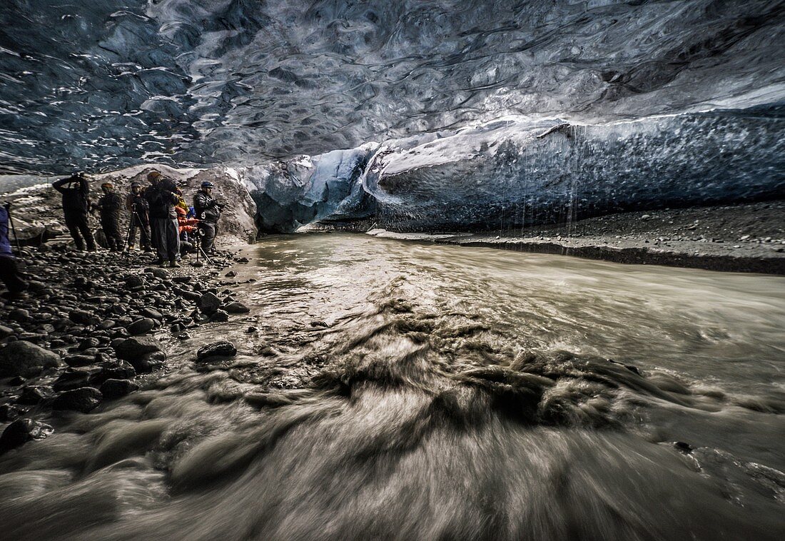 People exploring an ice cave, Breidamerkurjokull Glacier, Vatnajokull Ice Cap, Iceland.