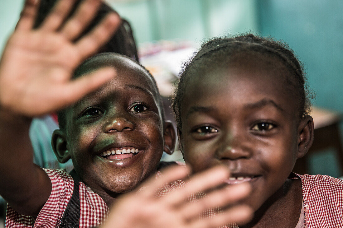 Local children waving happy into the camera, Sao Tome, Sao Tome and Principe, Africa