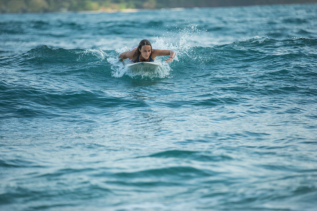 Young female surfer riding a wave, Sao Tome, Sao Tome and Príncipe, Africa