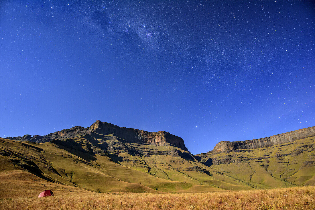 Stary sky above Giant's Castle and Longwall, small tent in middleground, Giant's Castle, Drakensberg, uKhahlamba-Drakensberg Park, UNESCO World Heritage Site Maloti-Drakensberg-Park, KwaZulu-Natal, South Africa