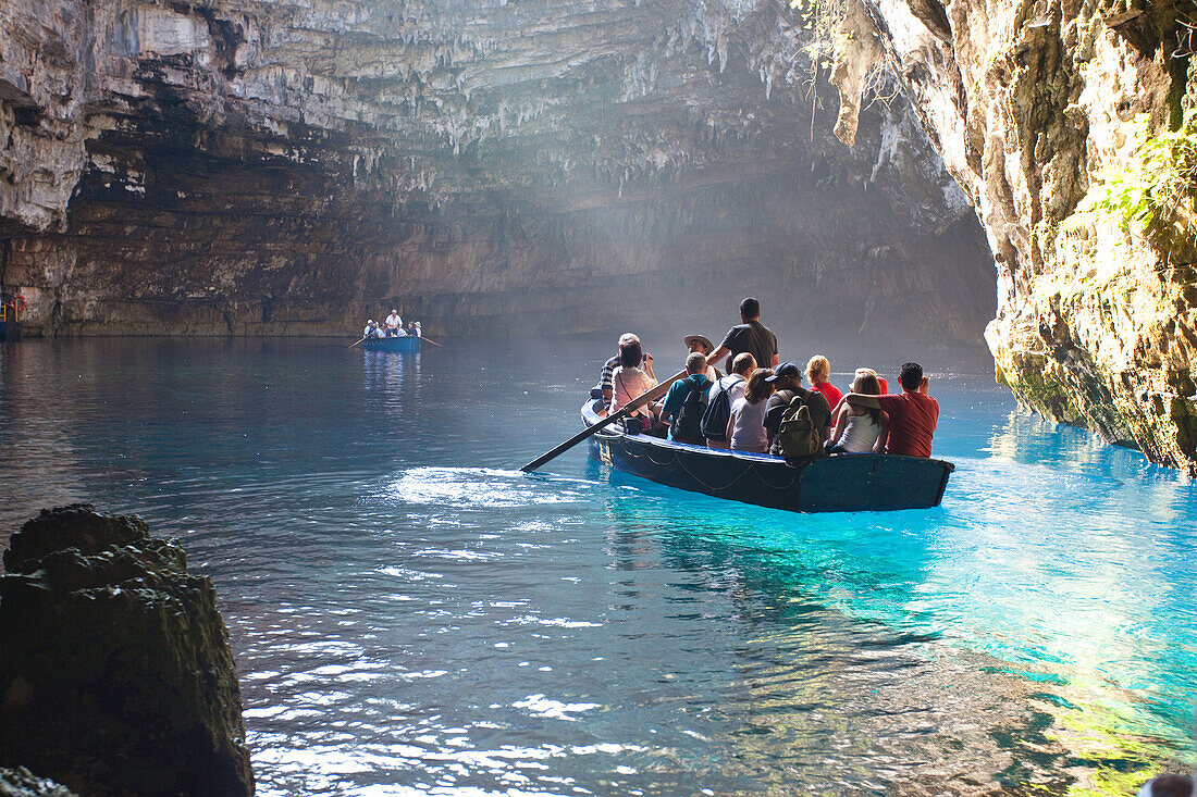 Tourist boats in Melissani Cave near Sami Cephalonia Ionian Islands Greece.