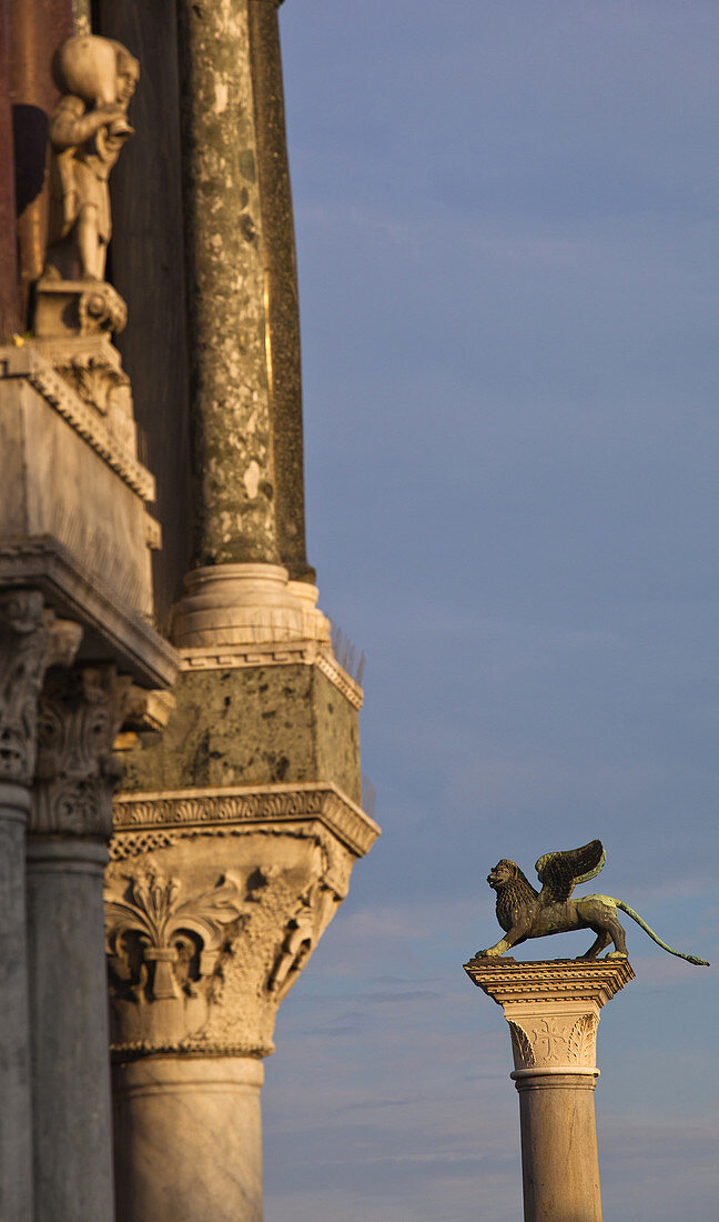 At left Saint Mark´s Basilica, Winged Lion column, St Mark´s square, Venice, Veneto, Italy, Europe.
