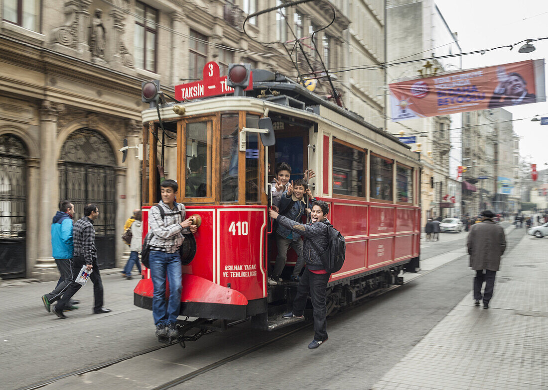 Kids playing on a tram in Istiklal Caddesi, Beyoglu, Istanbul, Turkey,.