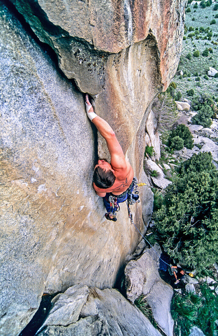 Rock climbing a route called Shake n Flake which is rated 5,10 and located on the Comp Wall at Castle Rocks State Park near the town of Almo in southern Idaho.