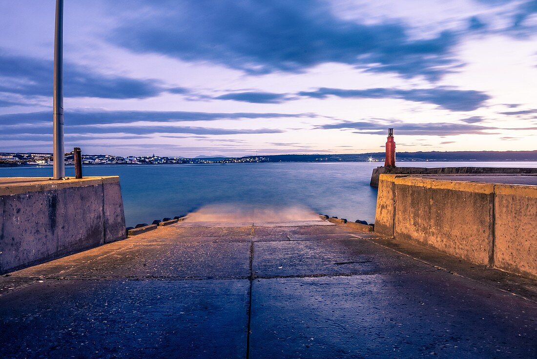 The beacon on the harbour wall. An empty slipway before the early morning boats start launching to go fishing. Still Bay, South Africa